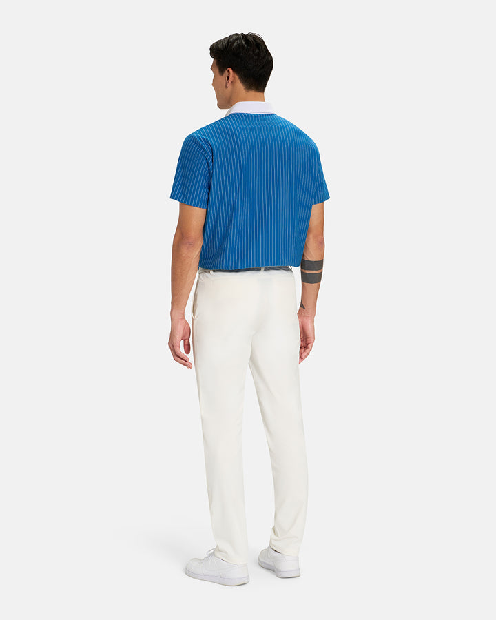 Full Body Back View of Royal Blue Spectator Stripe Polo Tucked on Asian Male Model wearing white pants white belt and white shoes #color_royal-blue