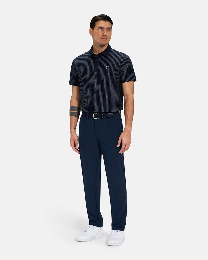 Full Body Front View of Navy Spectator Stripe Polo Tucked on Asian Male Model wearing navy pants black belt and white shoes #color_navy