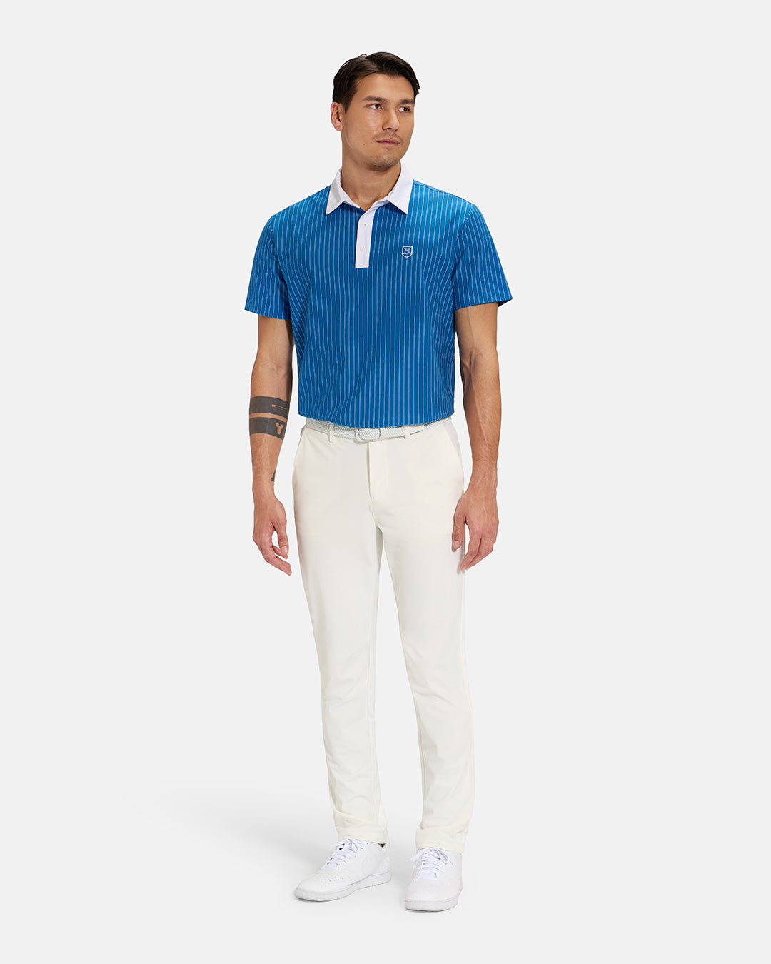 Full Body Front View of Royal Blue Spectator Stripe Polo Tucked on Asian Male Model wearing white pants white belt and white shoes #color_royal-blue