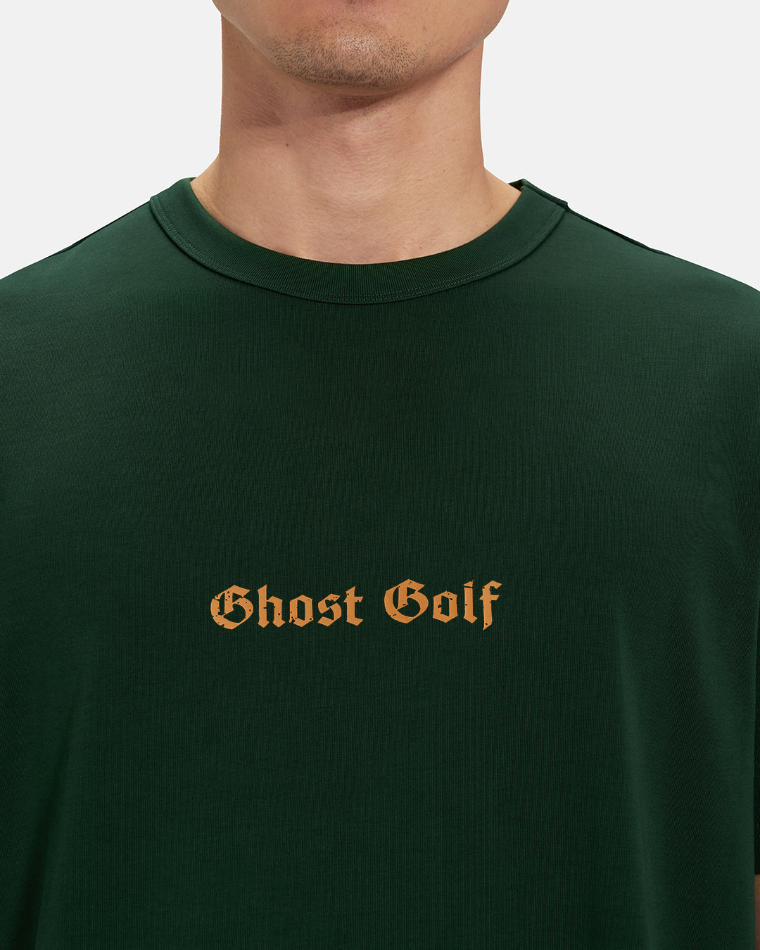 Front Closeup View of Bogey Green Spectator Tee on Asian Male Model with Ghost Golf #color_bogey-green