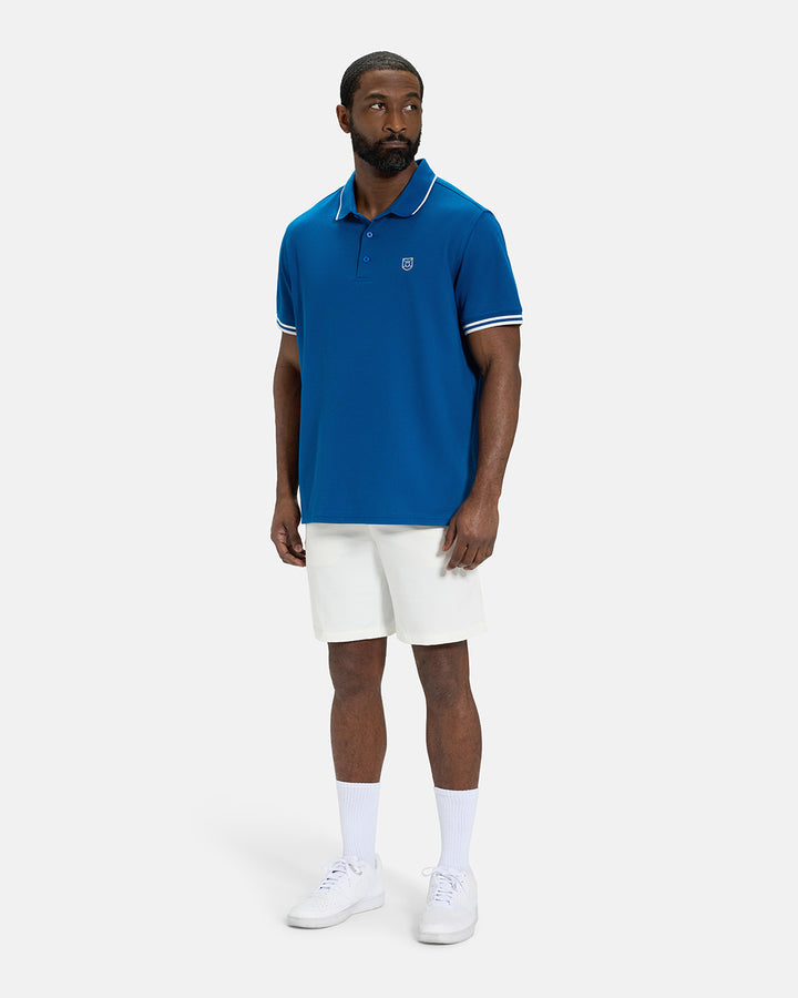 Full Body View of Royal Blue Spectator Tipped Collar Polo on Black Male Model wearing white shorts and white shoes #color_royal-blue
