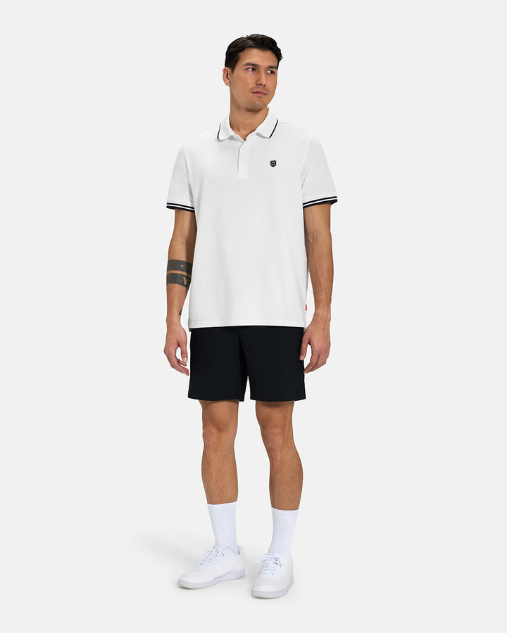 Full Body View of White Spectator Tipped Collar Polo on Asian Male Model wearing black shorts  and white shoes #color_white