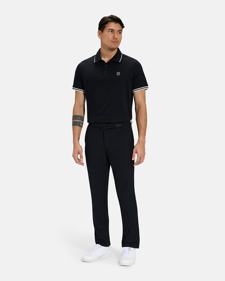 Full Body View of Black Spectator Tipped Collar Polo Tucked on Asian Male Model wearing black pants black belt and white shoes #color_black