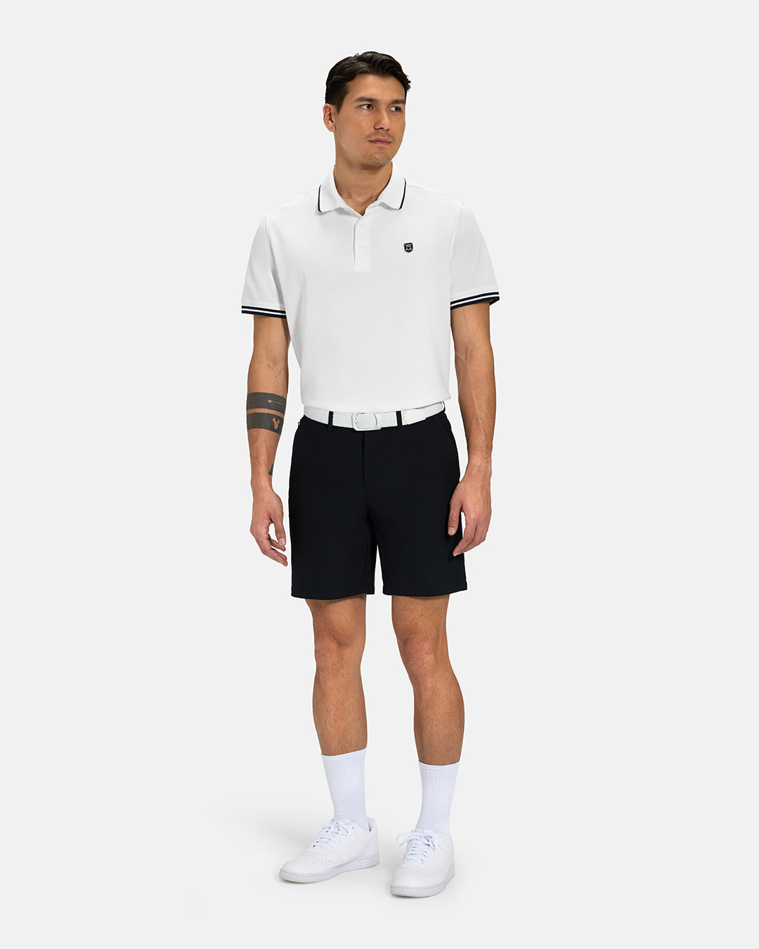 Full Body View of White Spectator Tipped Collar Polo Tucked on Asian Male Model wearing black shorts white belt and white shoes #color_white