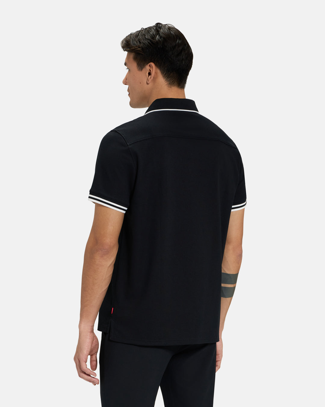 Back View of Black Spectator Tipped Collar Polo on Asian Male Model #color_black