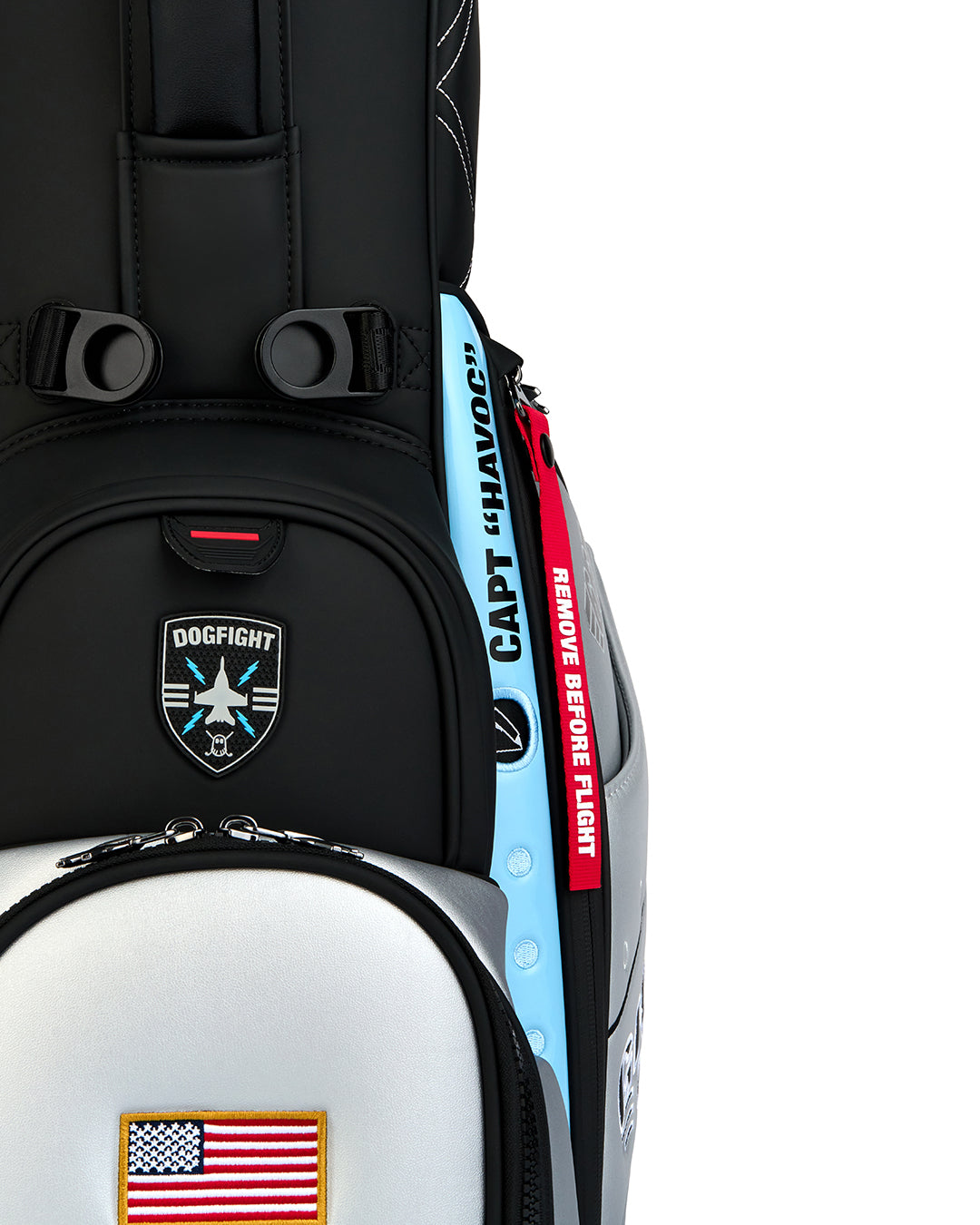 Close-up detail shot of the Striker Anyday Bag showcasing the magnetic rangefinder pocket. Features a badge-style front patch with a fighter jet icon and "Dogfight" text. Detailed product image highlighting the premium materials, functional magnetic closure, and aviation-inspired Ghost Golf design elements.