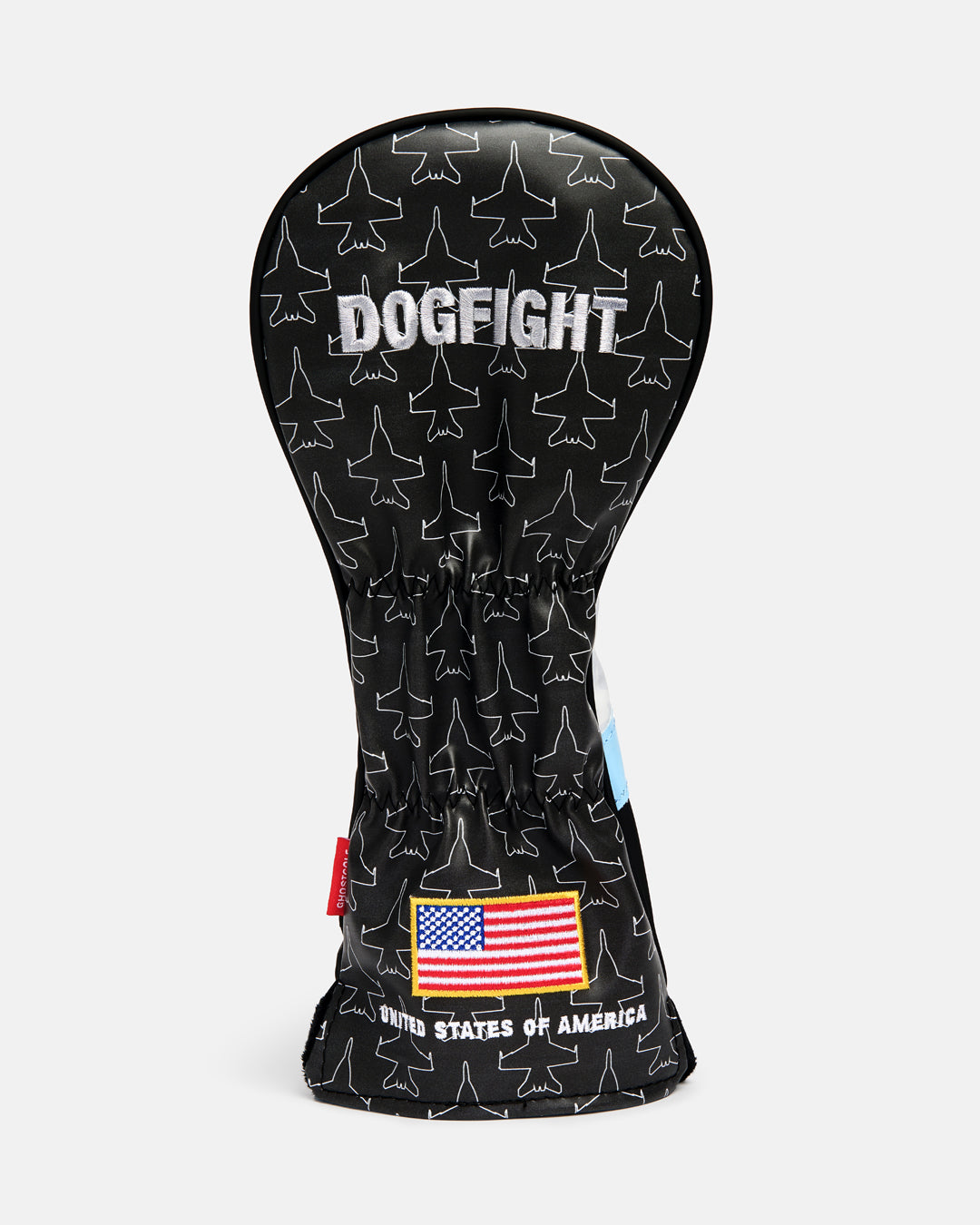 Back product shot of the Striker Secondary 5 Wood Head Cover showcasing an all-over fighter jet icon pattern. Features "Dogfight" embroidery at the top and an embroidered USA flag at the bottom with "United States of America" text beneath it. Rear-facing view highlighting the aviation-inspired graphics, premium embroidery, and patriotic Ghost Golf design details. #size_3-wood