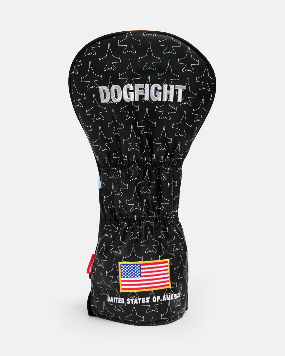 Back product shot of the Striker Secondary Driver Head Cover showcasing an all-over fighter jet icon pattern. Features "Dogfight" embroidery at the top and an embroidered USA flag at the bottom with "United States of America" text beneath it. Rear-facing view highlighting the aviation-inspired graphics, premium embroidery, and patriotic Ghost Golf design details. #size_driver
