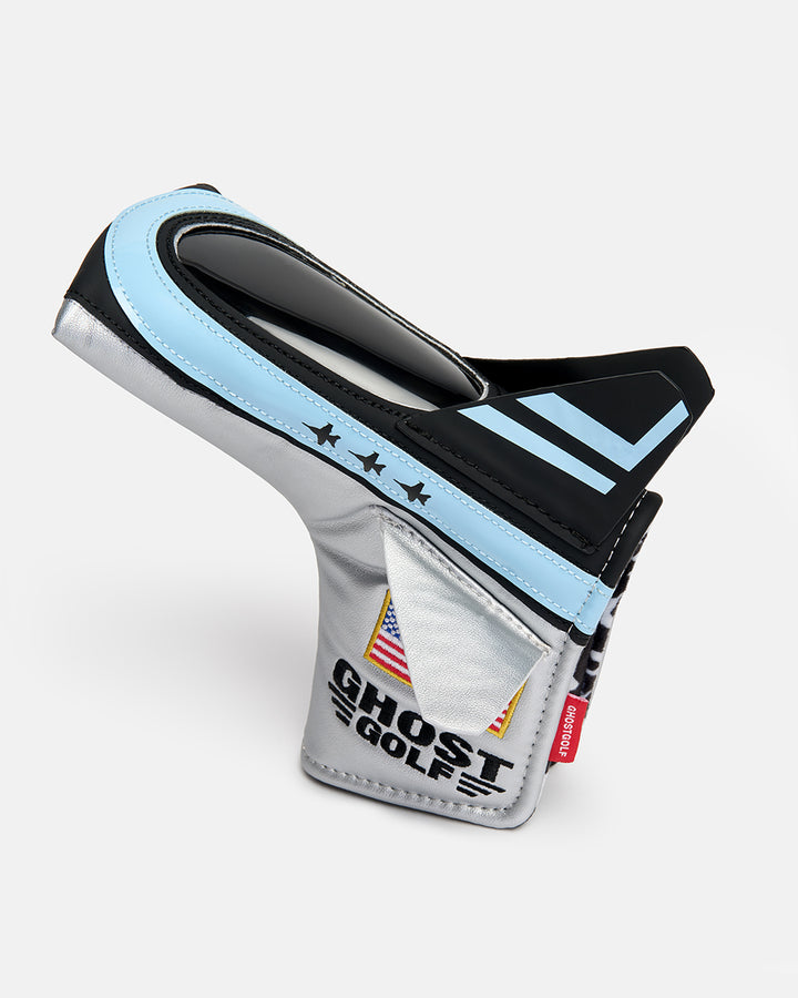 Side product shot of the Striker Blade Putter Cover designed in the shape of a fighter jet, featuring an embroidered Ghost Golf logo and USA flag. Angled profile view highlighting the aircraft-inspired silhouette, premium embroidery, patriotic detailing, and signature Ghost Golf craftsmanship.