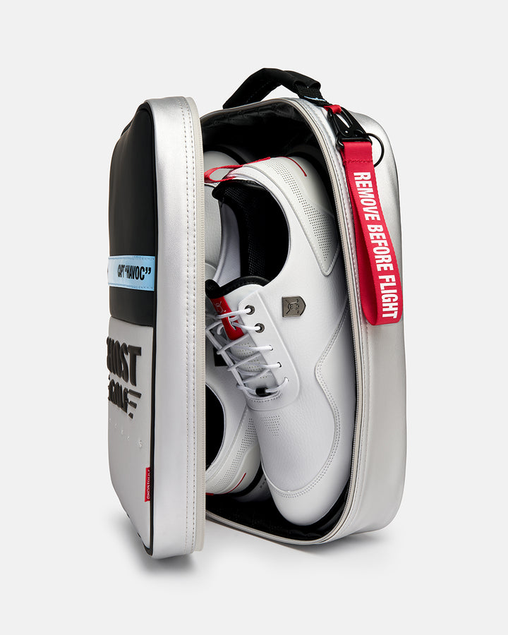 Three-quarter view of the Striker Shoe Bag with shoes stored inside, showcasing the spacious main compartment and functional storage design. Angled product image highlighting the bag's capacity, premium construction, and Ghost Golf branding.