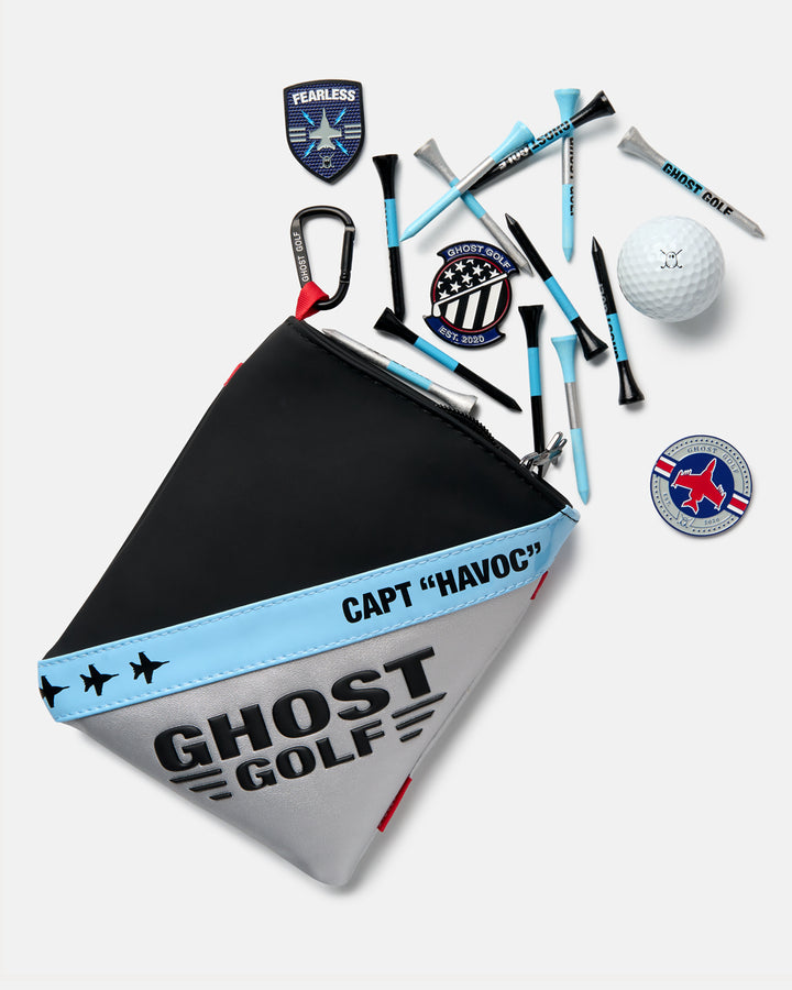 Front view of the Striker Utility Pouch with golf tees, ball markers, and a golf ball spilling out of the pouch.