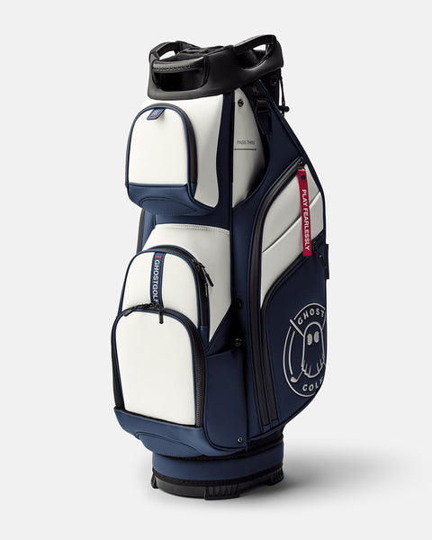 GHOSTGOLF GT-14 Valor golf bag in white and navy, shown at a three-quarter angle with zippered pockets, an embossed Ghost Golf logo, and a red “Play Fearlessly” tag.