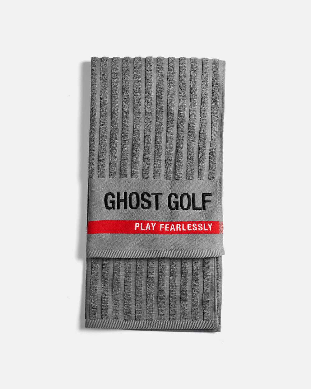 Product shot of Grey Tour Pro Caddie Towel folded flat, featuring the Ghost Golf logo on the bottom right, a red stripe across the bottom, and “Play Fearlessly” text #color_grey